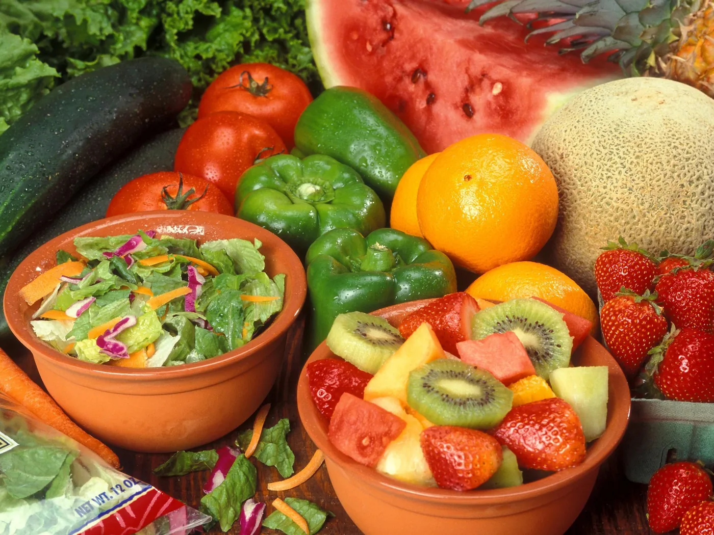 Colorful fresh fruit, vegetables, and salad arranged on a table